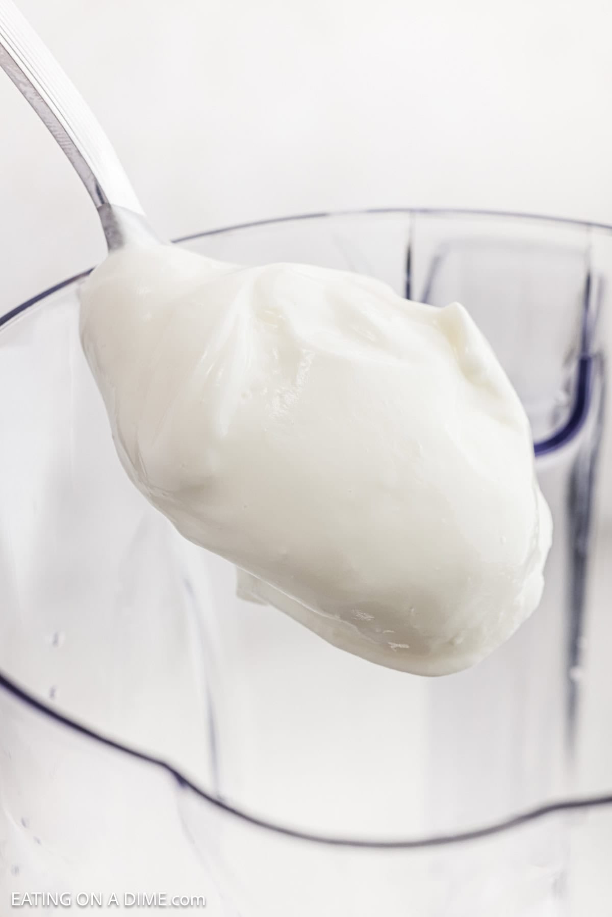 Adding yogurt to the blender.