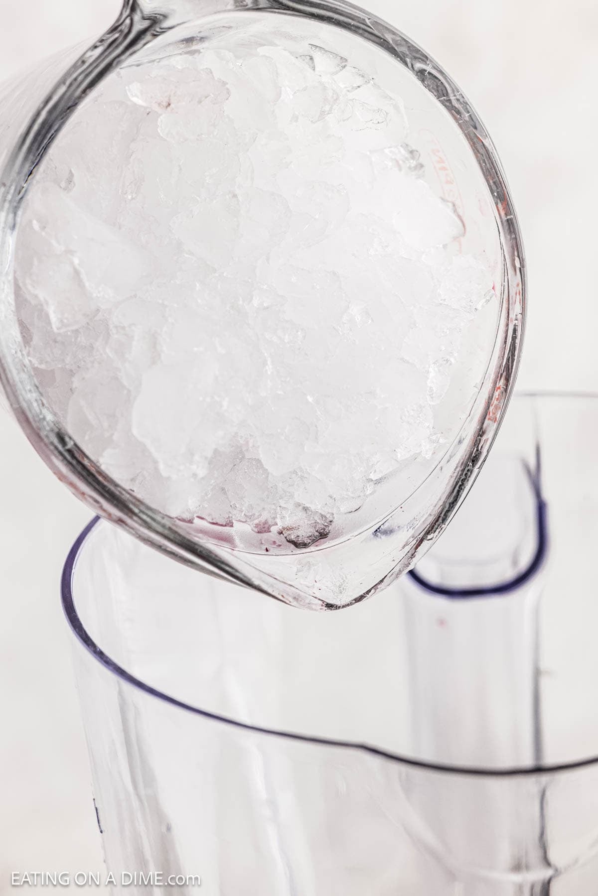Pouring in crushed ice into the blender.