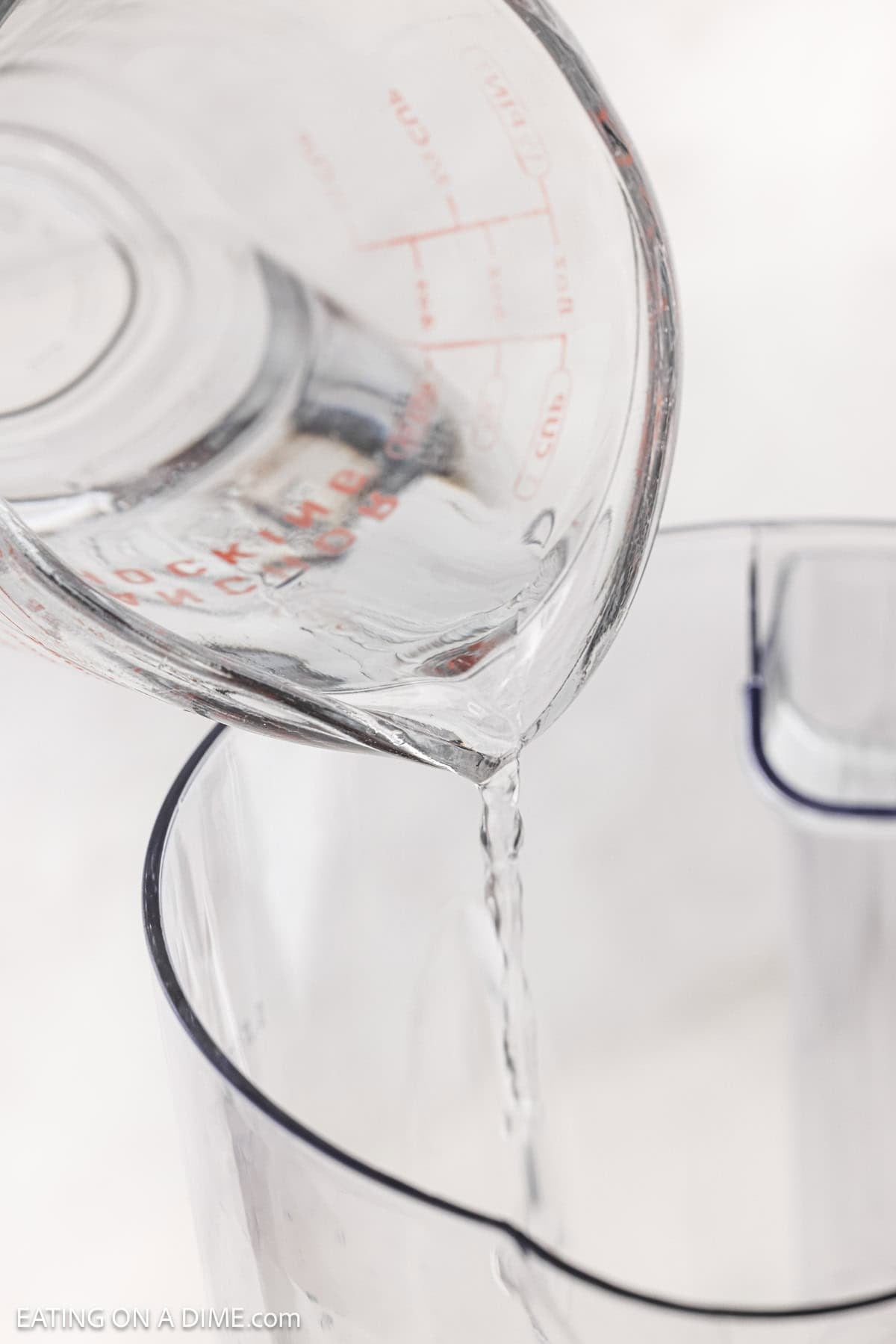 Pouring water in a blender.