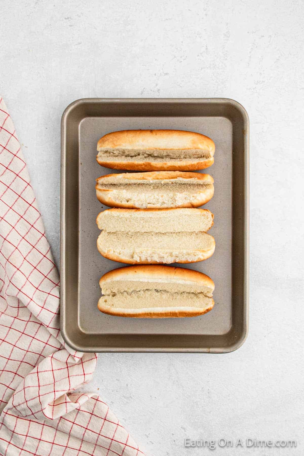 Hot dog buns on a baking sheet