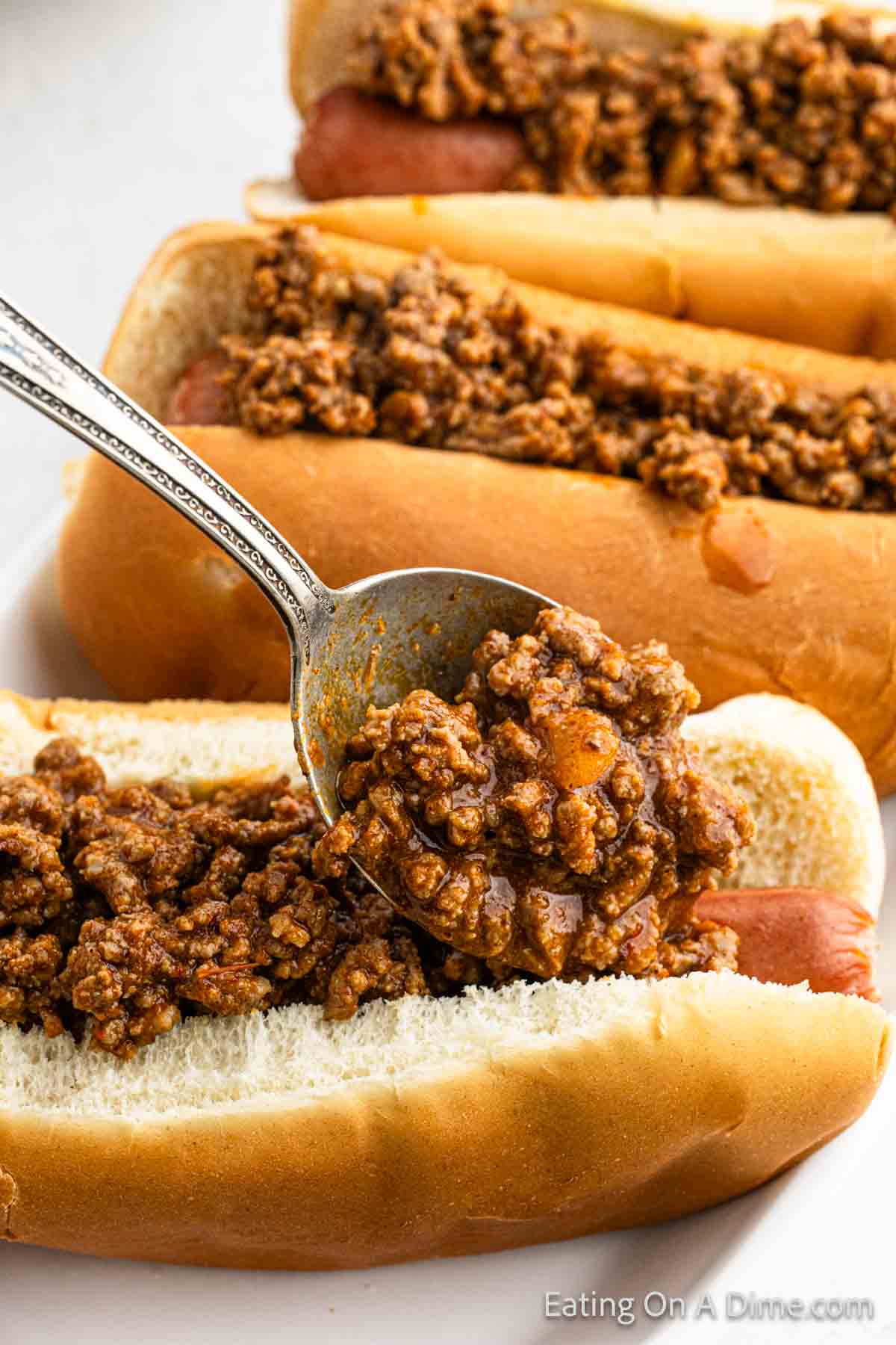 Hot dogs topped with chili 