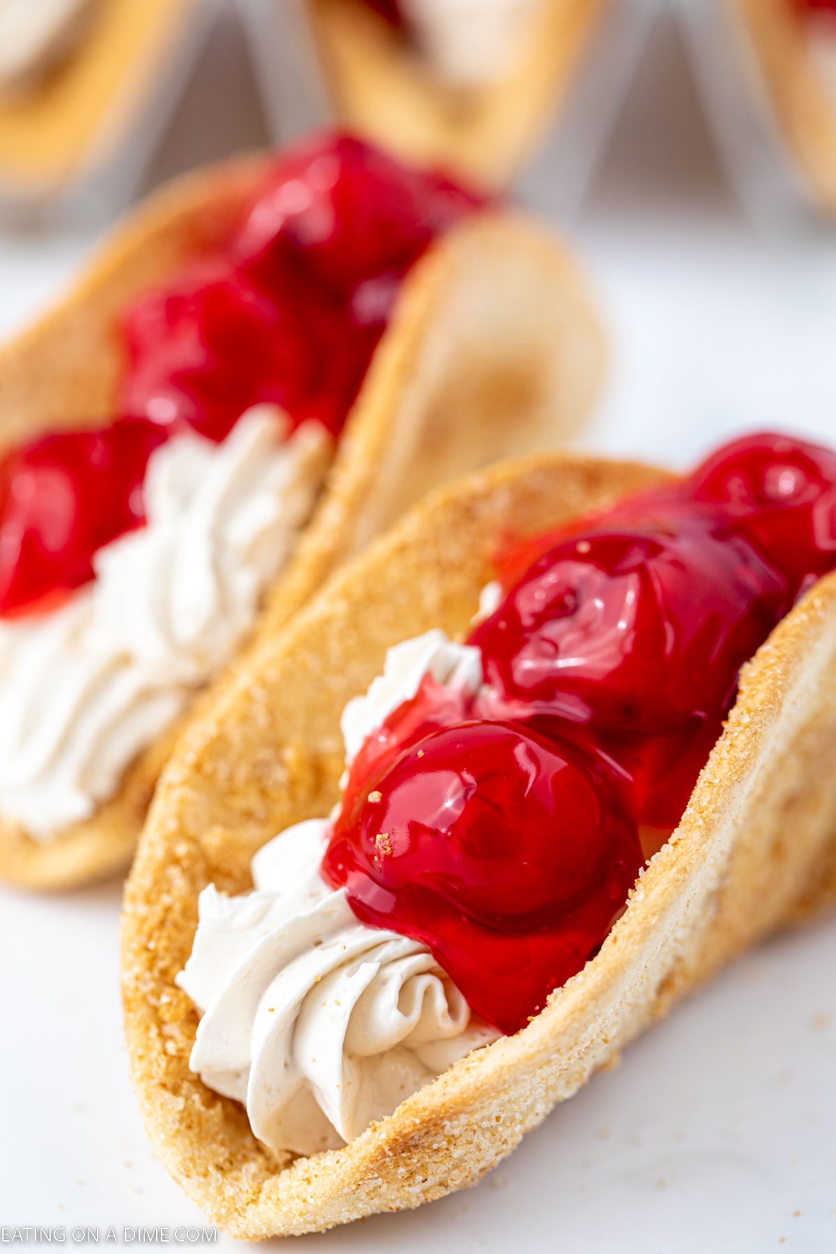 Cheesecake Tacos topped with cherry pie filling