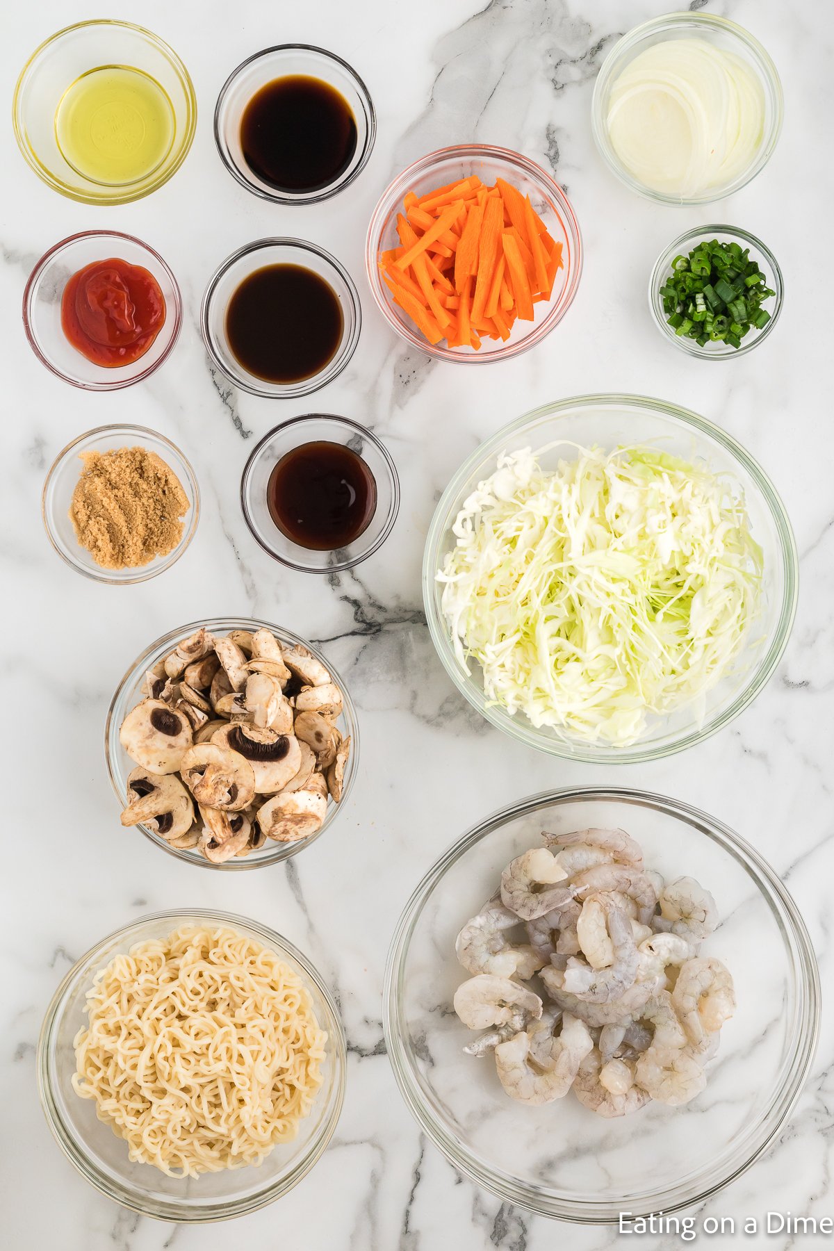 ingredients needed for shrimp yakisoba - worcestershire sauce, oyster sauce, ketchup, soy sauce, brown sugar, avocado oil, shrimp yakisoba noodles, onion, carrot, green cabbage, green onions, slice mushrooms