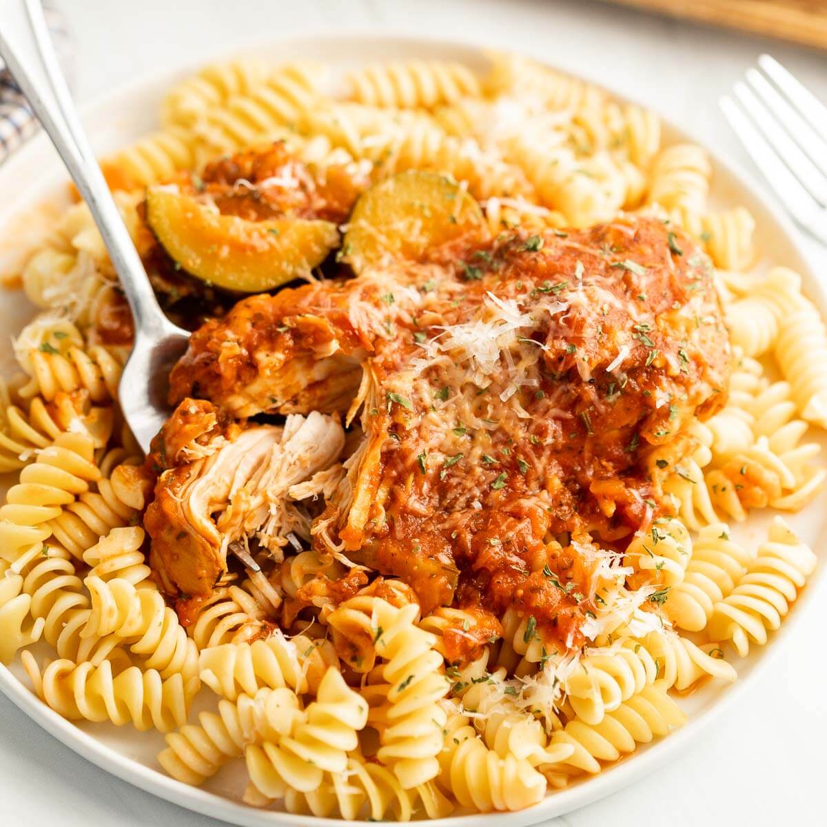 Chicken and Zucchini over pasta on a plate