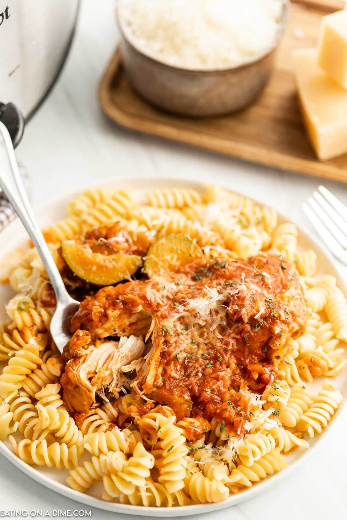 Chicken and Zucchini over pasta on a plate