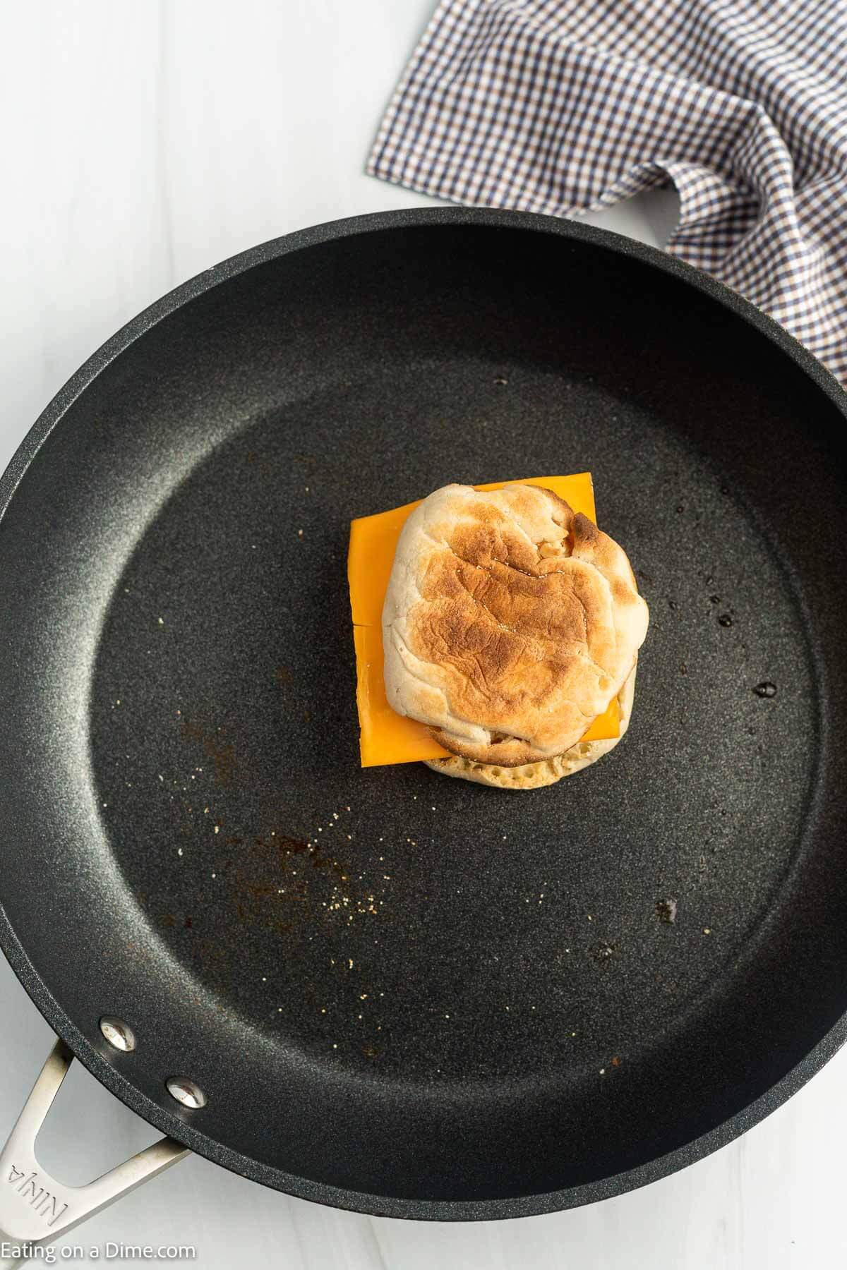 Assembled Egg McMuffin in a skillet.
