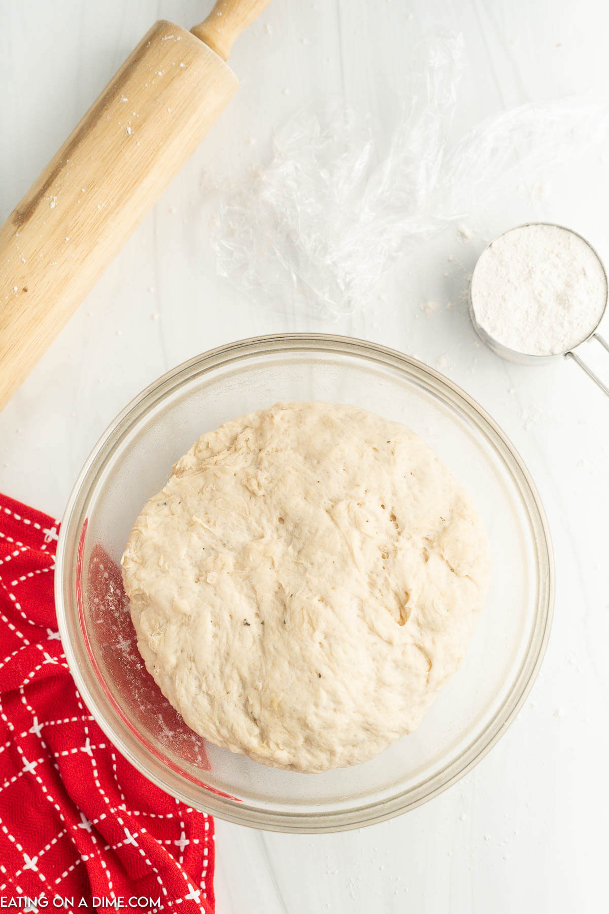 Allow the pizza dough to rise in a bowl