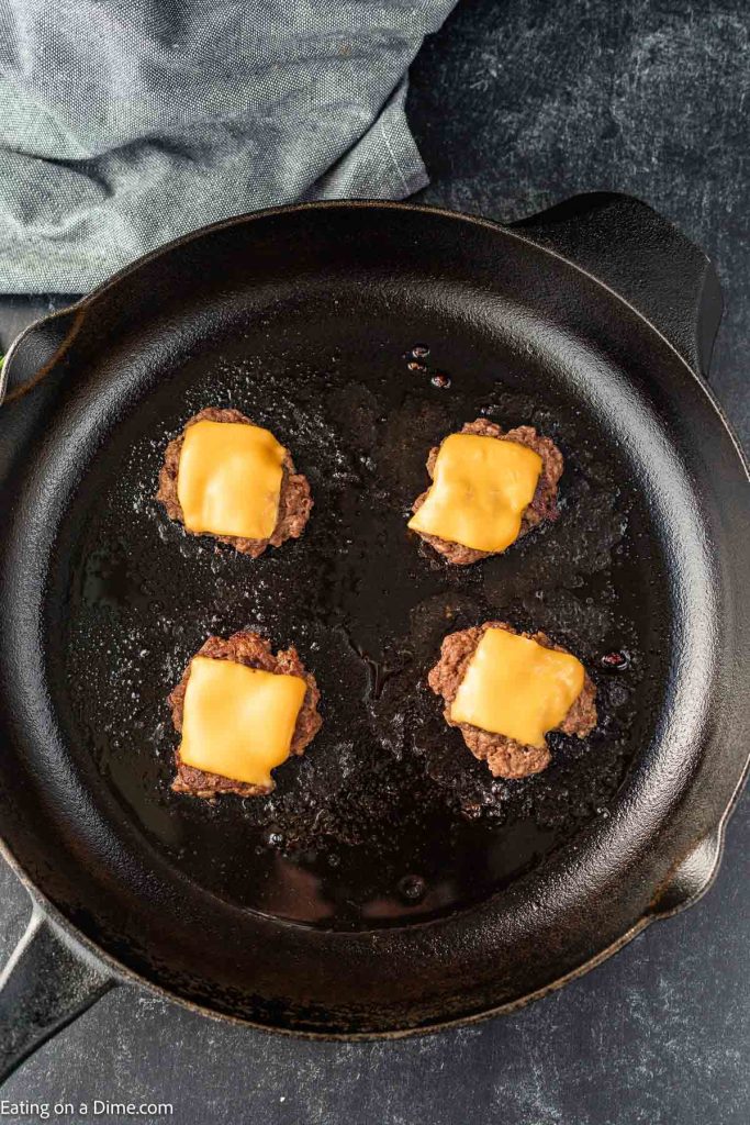 Patties with cheese in pan. 