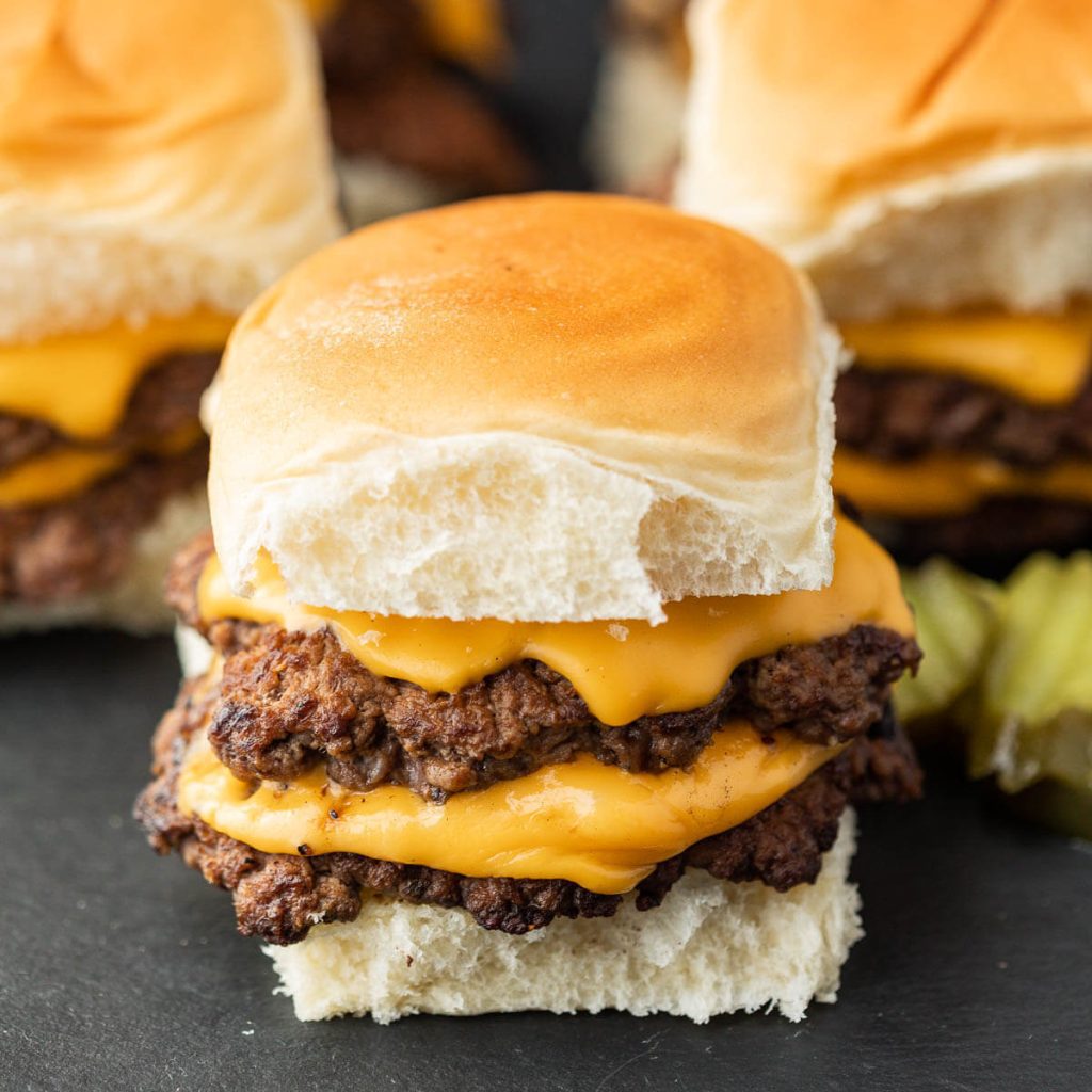 Smash burger sliders with toppings. 
