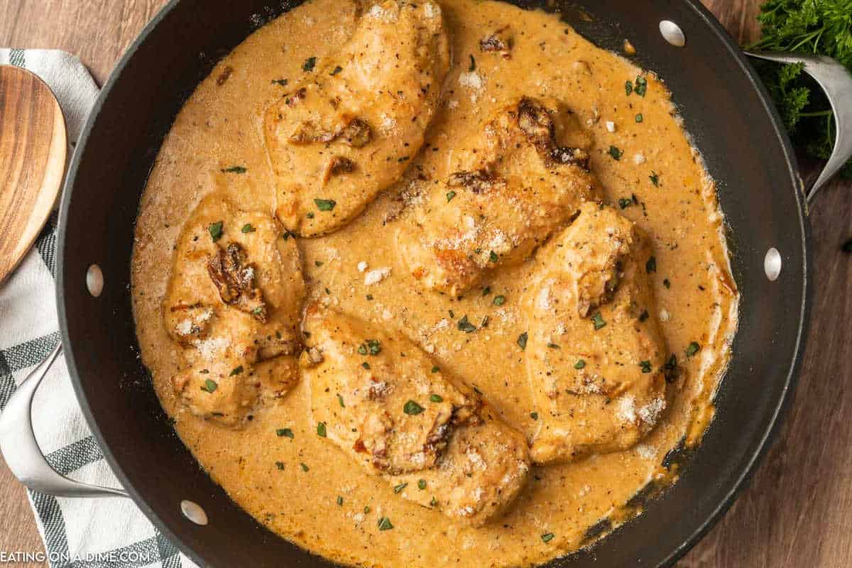 Marry Me Chicken in gravy in a cast iron skillet.