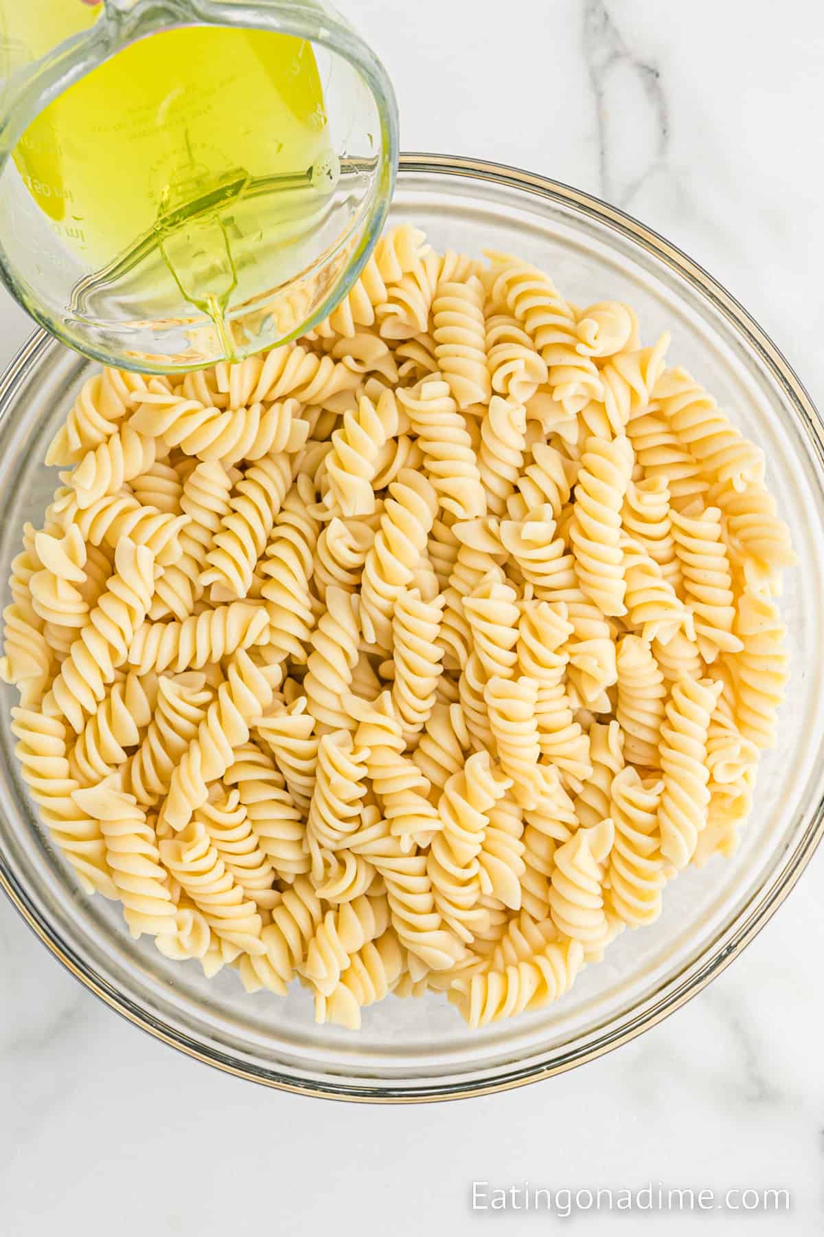 Cook Rotini Pasta in a bowl with pickle Juice being poured over the top