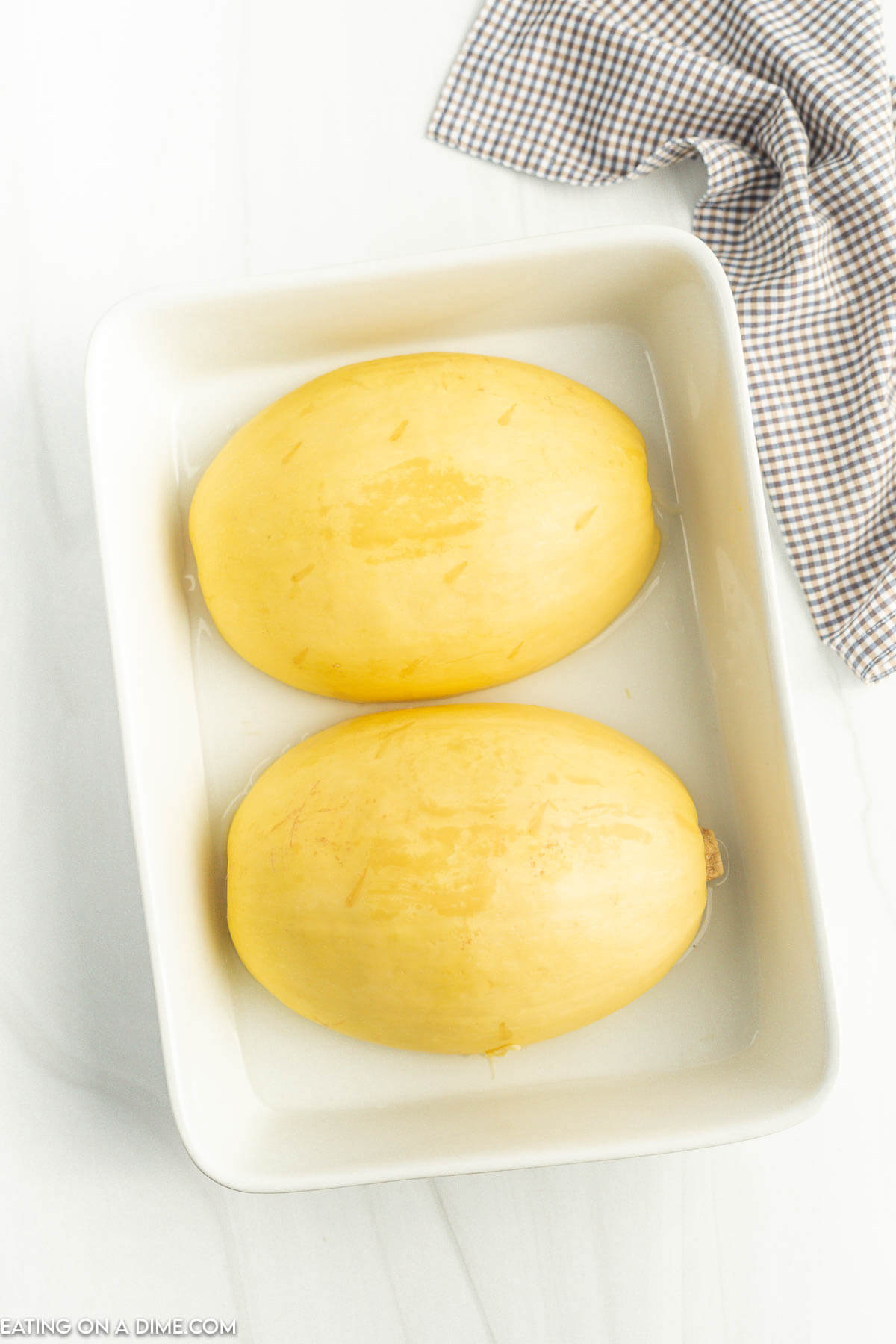 Spaghetti squash face down in a baking dish