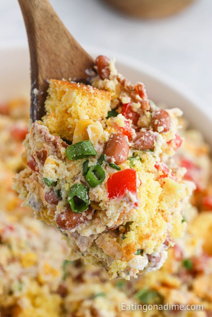 Bowl of Cornbread Salad on a wooden spoon