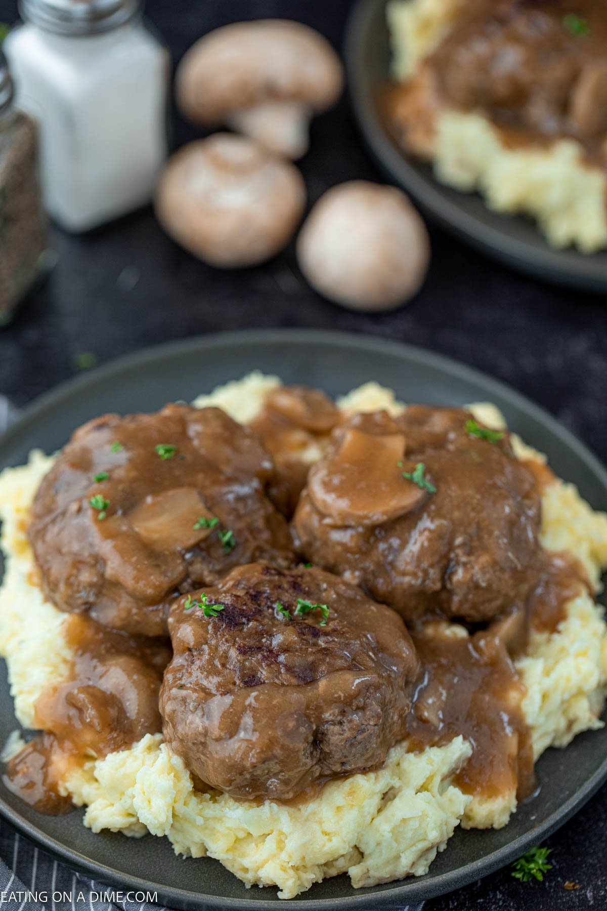 Salisbury Steak over mashed potatoes on a plate