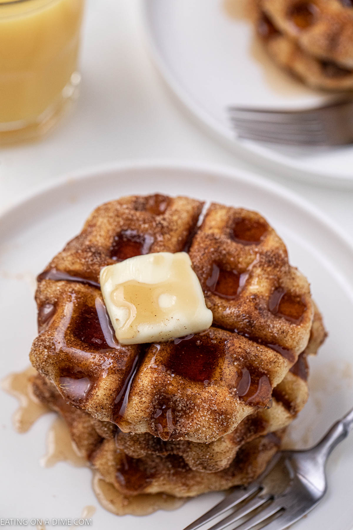Cinnamon and Sugar biscuit waffle topped with butter and syrup on a plate