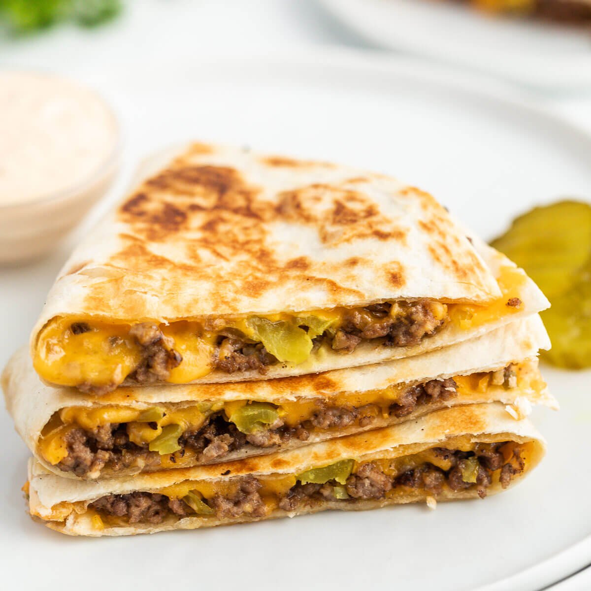 Cheeseburger Quesadilla stacked on a plate