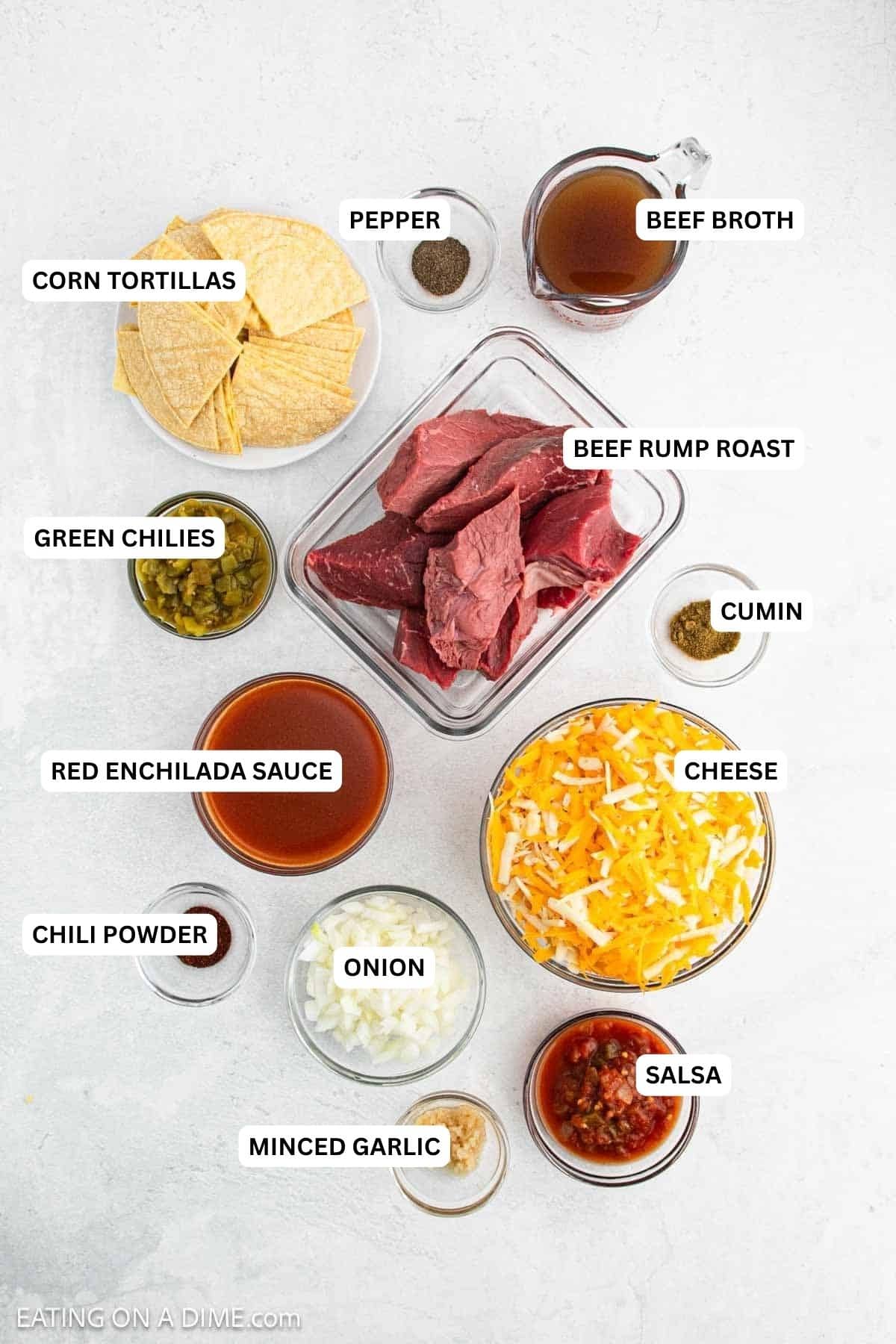 Ingredients for recipe: corn tortillas, pepper, beef broth, beef roast, green chilies, cumin, red enchilada sauce, cheese, chili powder, onion, salsa and garlic.