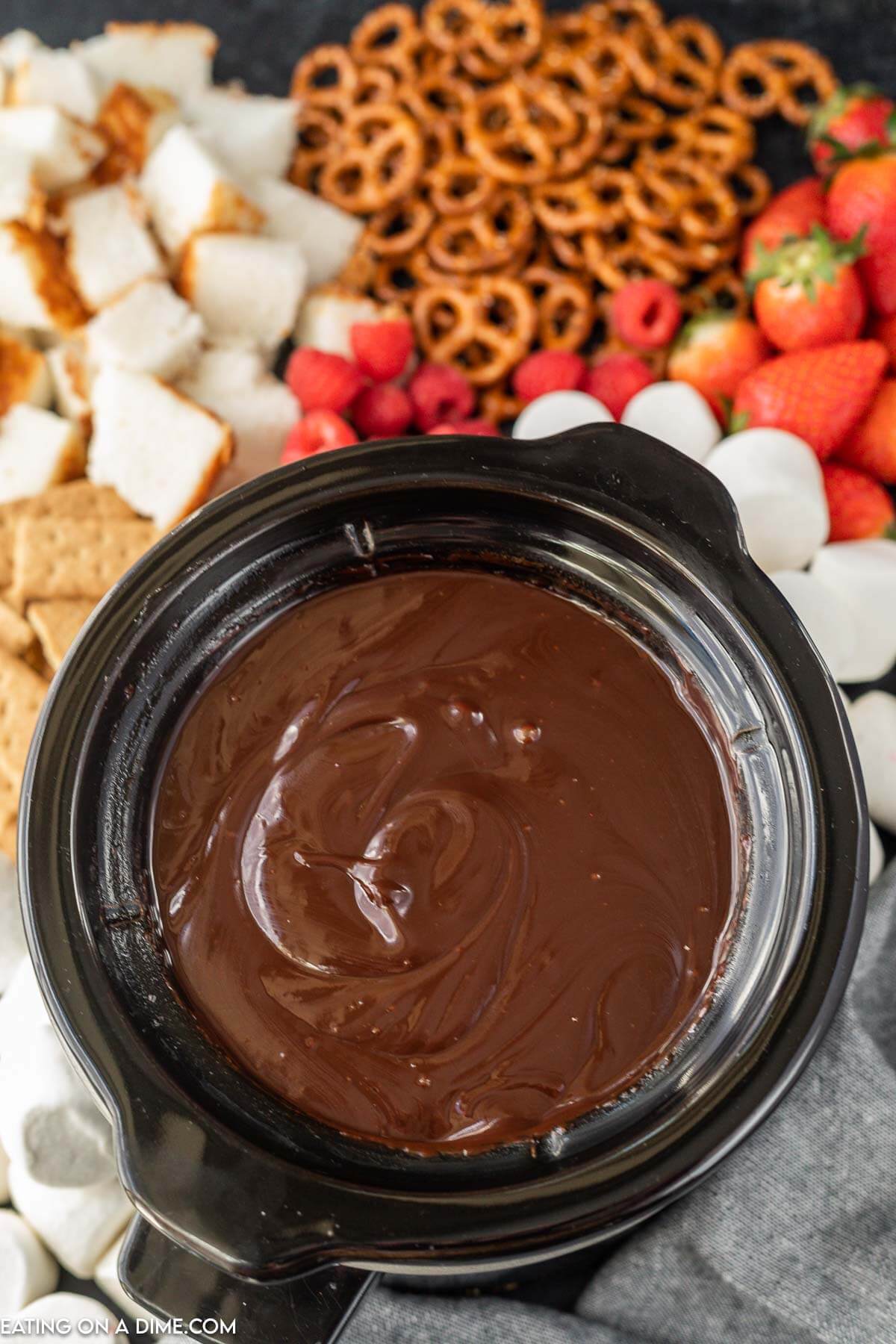 Melted chocolate in the crock pot a side of strawberries, graham crackers and marshmallows