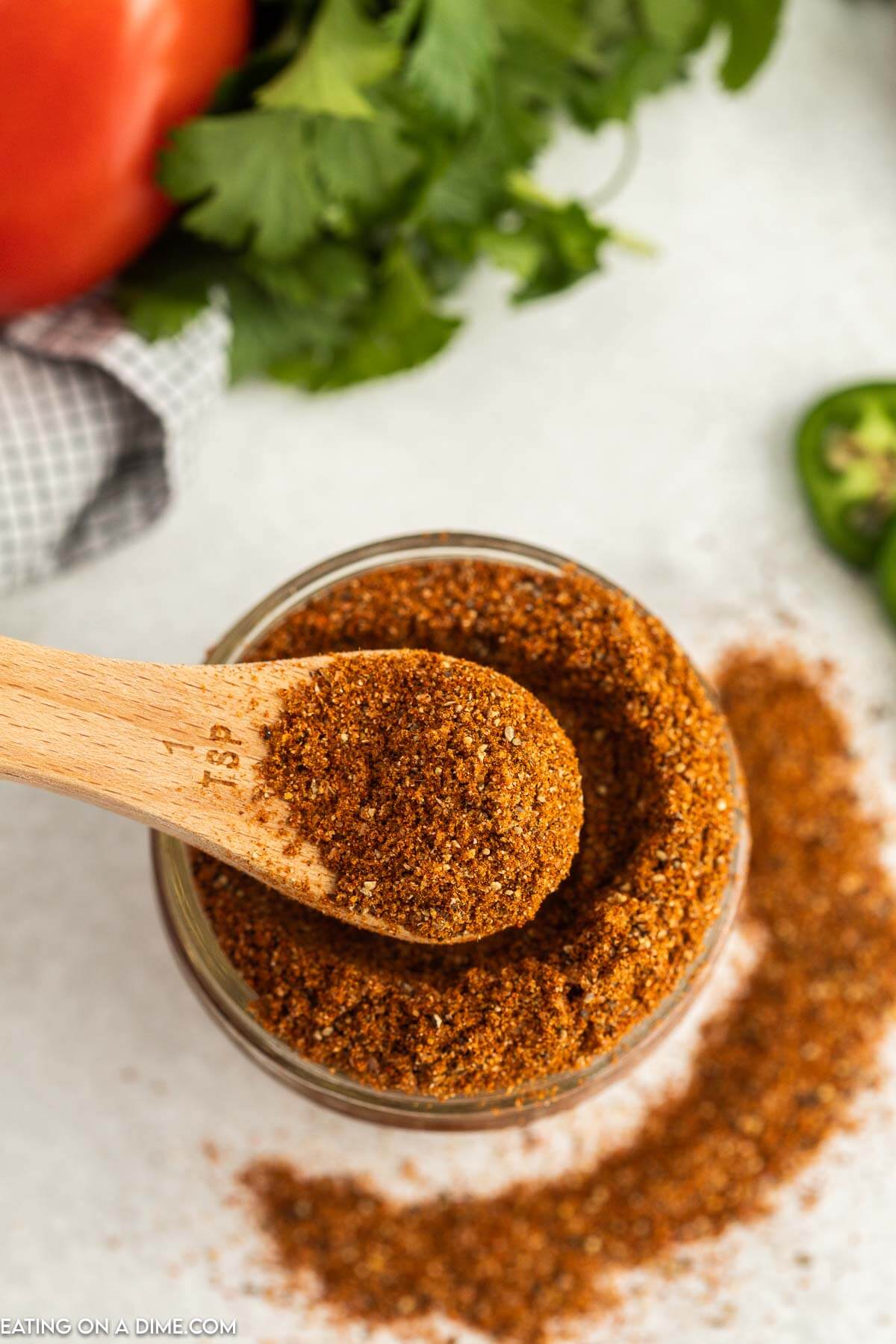 Taco Seasoning in a jar with a teaspoon