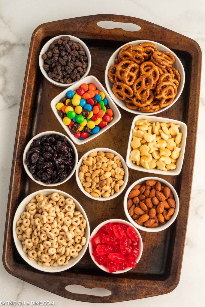 Bowls of snacks and candy in bowls on a baking sheet