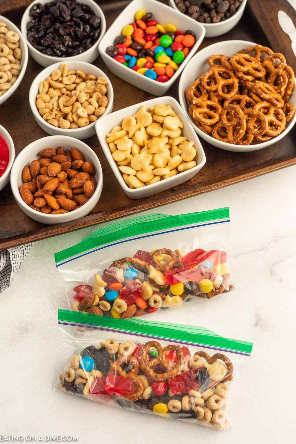 Trail mix bar set up on a baking sheet and combined in a snack bag