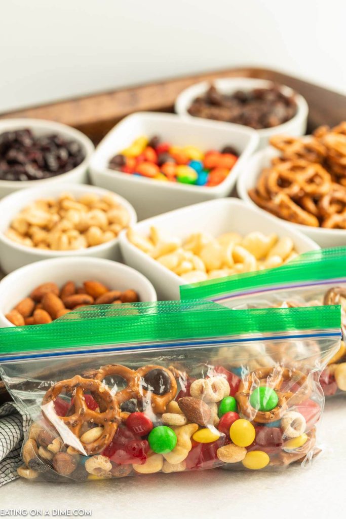 Trail mix bar set up on a baking sheet and combined in a snack bag