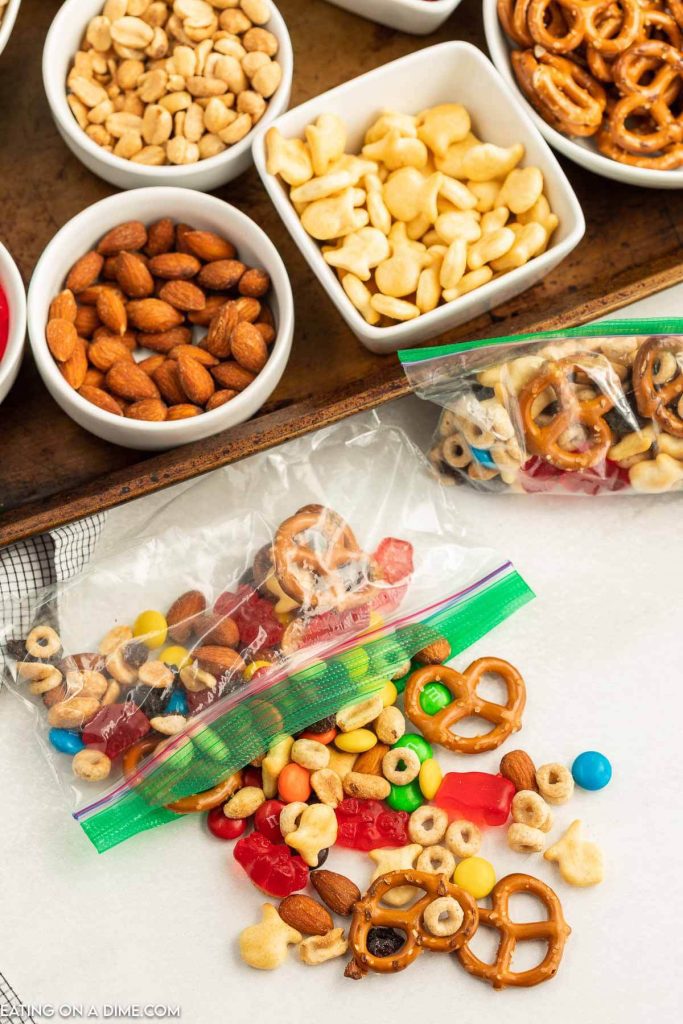 Trail mix bar set up on a baking sheet and combined in a snack bag