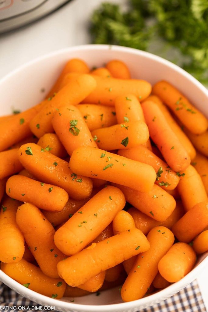Cooked Baby Carrots in a white bowl