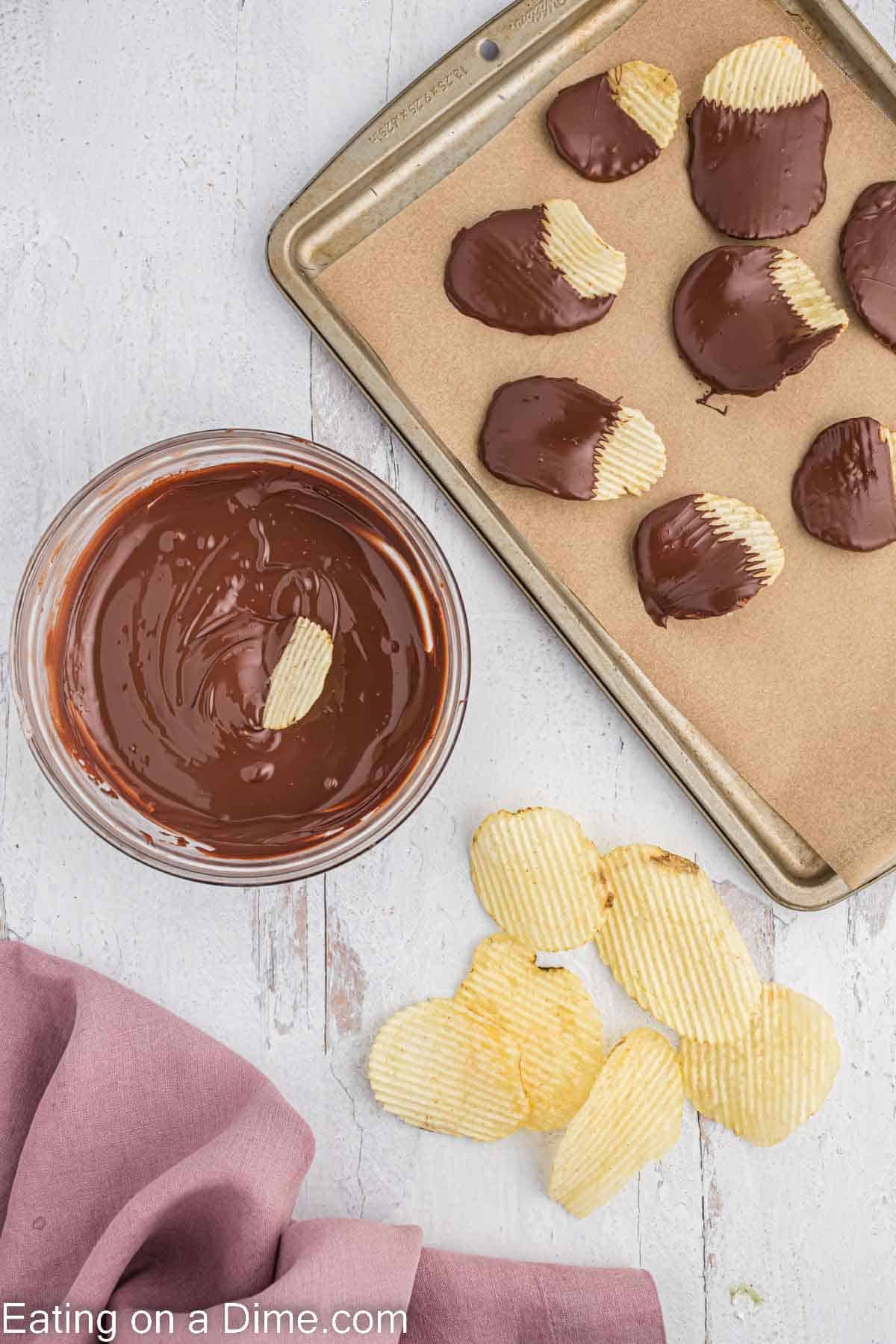 chocolate dipped potato chips on a baking sheet