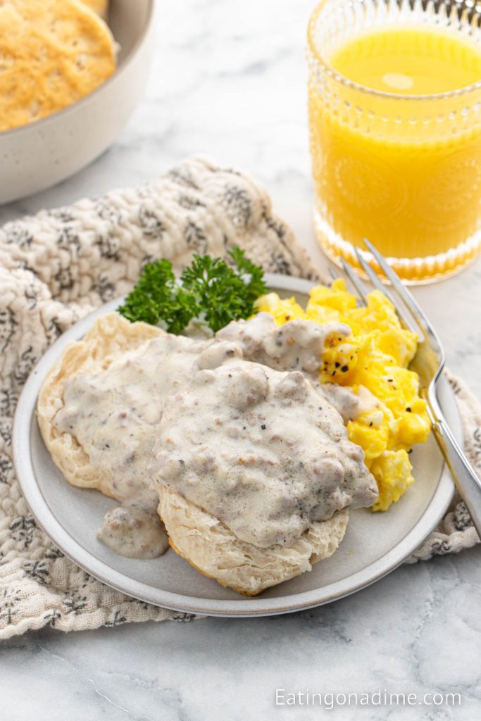 Sausage and Biscuit gravy on a plate with scrambled eggs