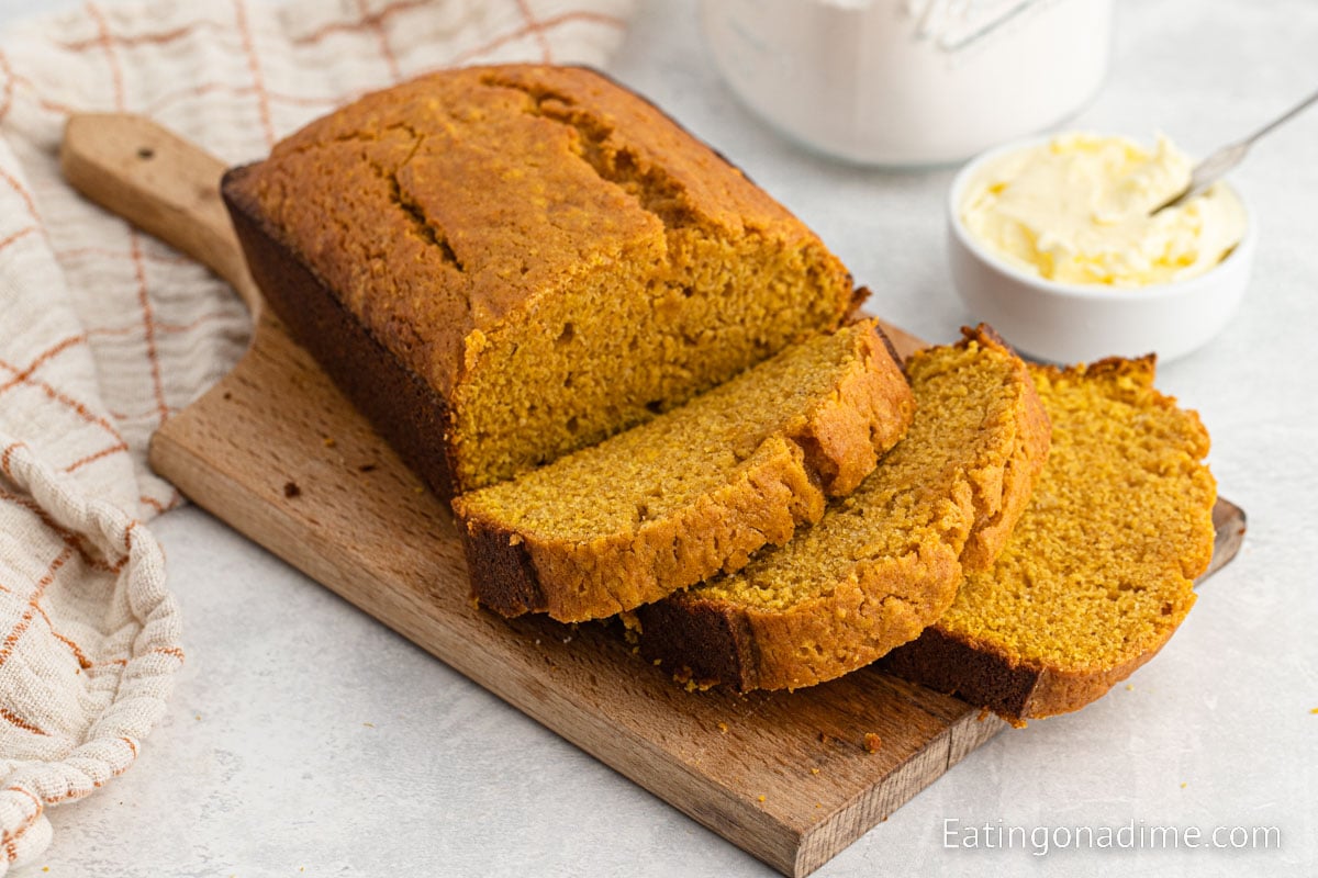 Slice pumpkin bread on a cutting board