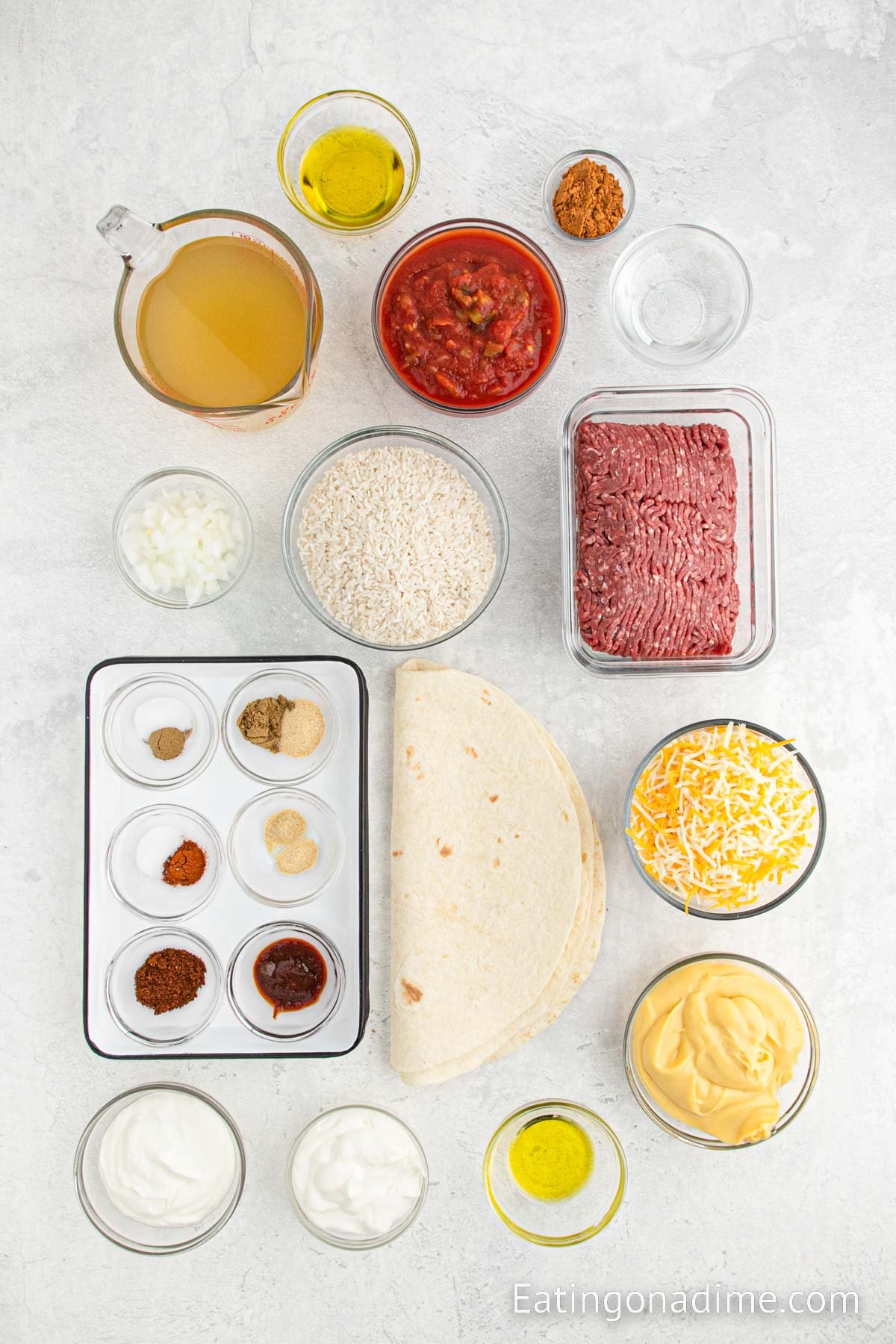 Ingredients needed - Ground beef, taco seasoning, olive oil, onion, rice, broth, salsa, garlic salt, cumin, sour cream, sauce, chili powder, sugar, salt, cumin, paprika, garlic powder, onion powder, tortillas, cheese sauce, cheese