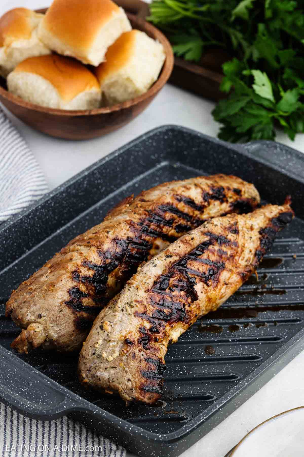 Cooked pork tenderloin in a grill pan.