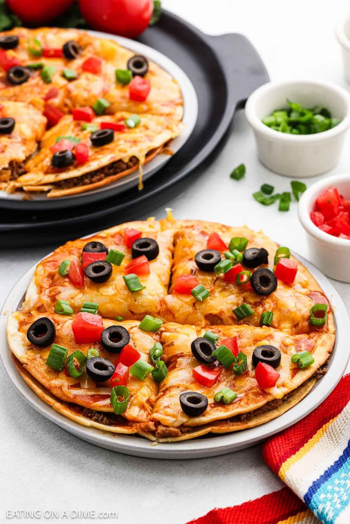 Close up image of Mexican Pizza on a white plate.