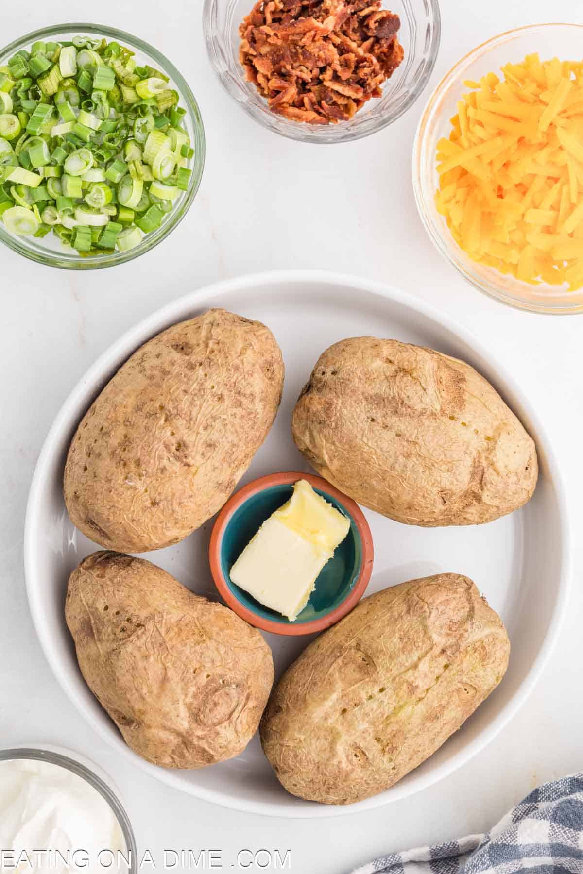 Baked Potatoes on a plate with butter