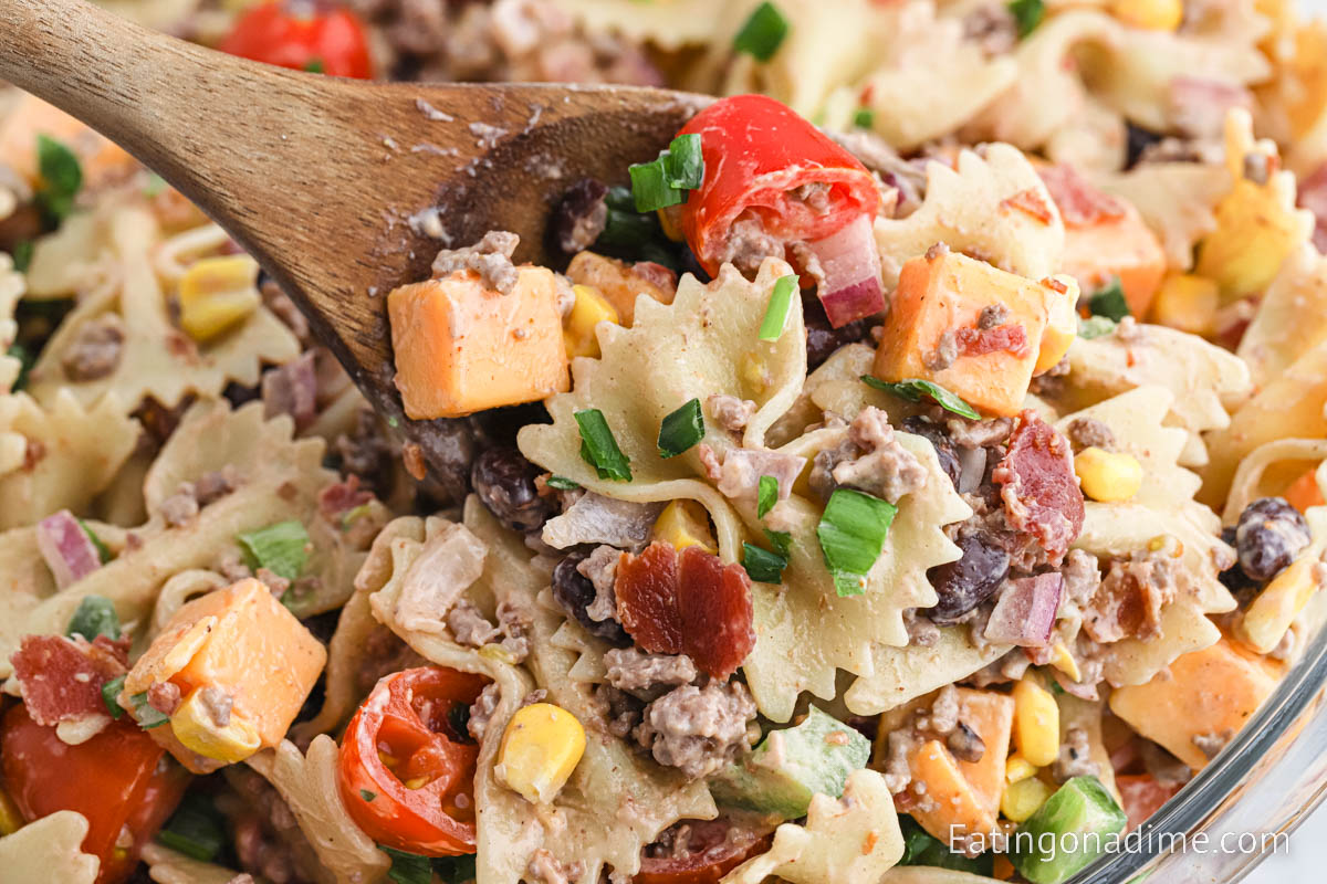 Cowboy Pasta Salad in a bowl with a wooden spoon