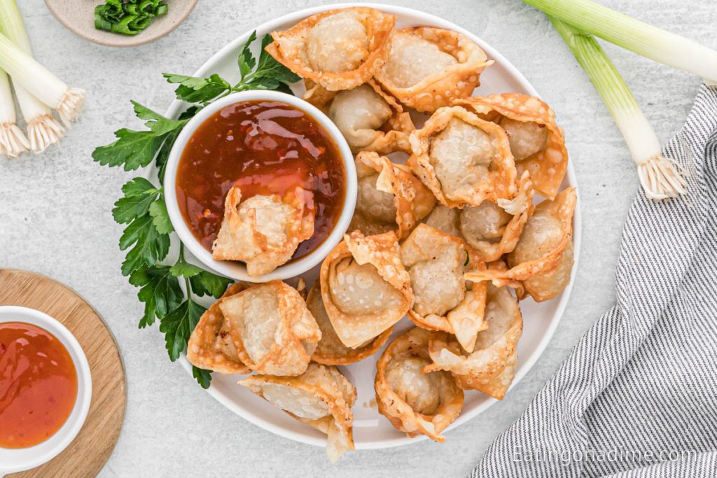 Fried wontons stacked on a platter
