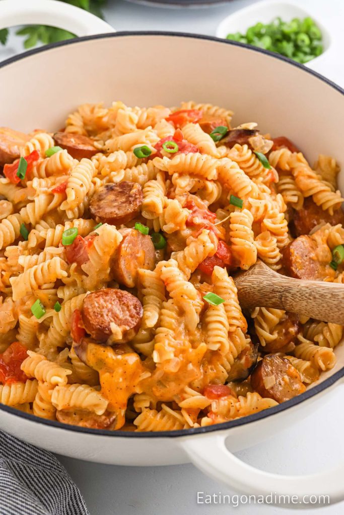 Kielbasa and Pasta with a serving on a wooden spoon in a dish