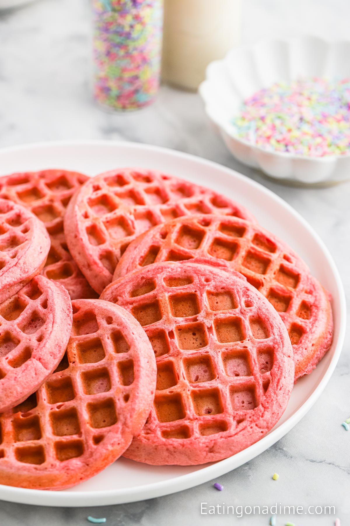 Pink Waffles Stacked on a white plate 