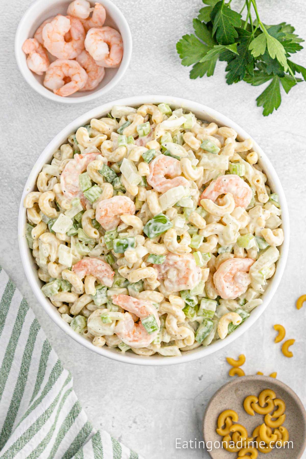 Macaroni Salad with shrimp in a bowl with a small bowl with cooked shrimp