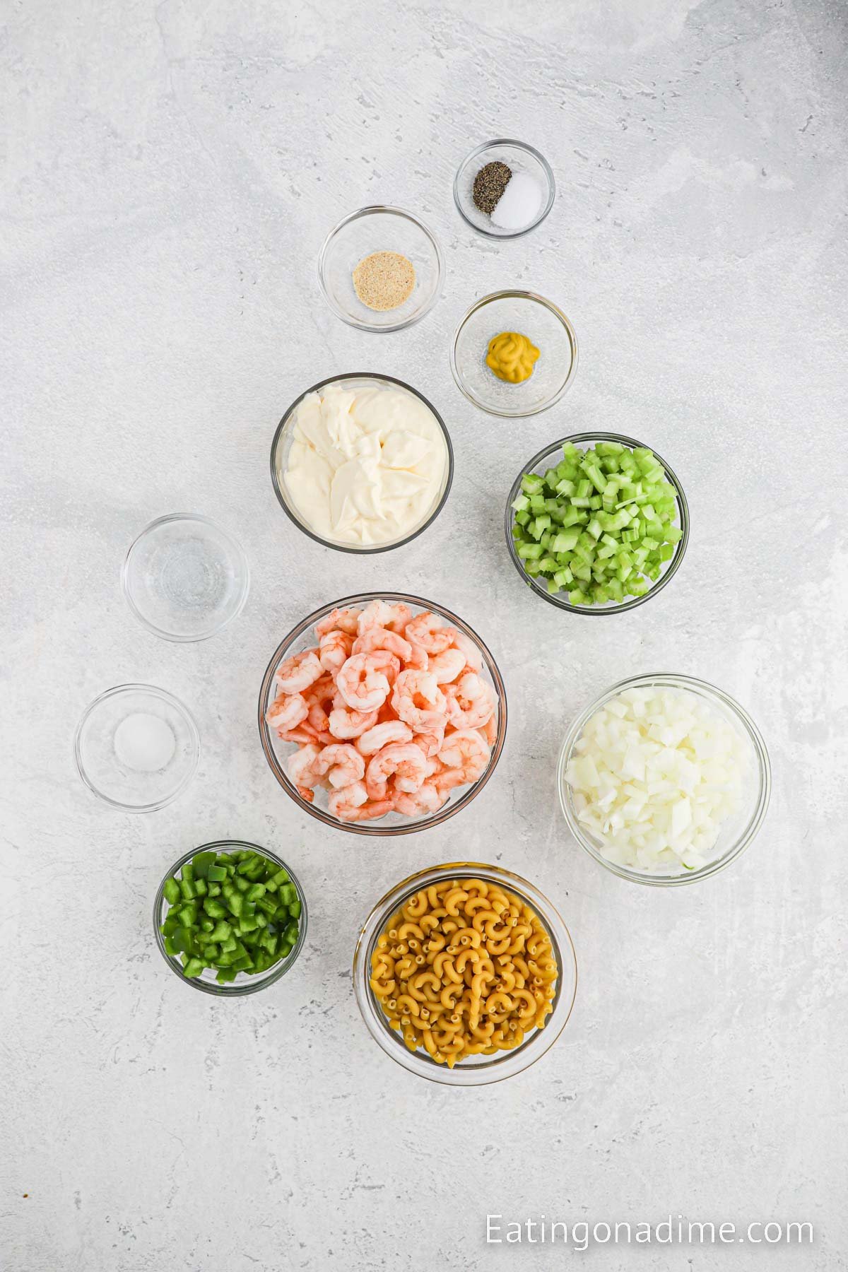 Ingredients needed for Shrimp Macaroni Salad - Macaroni Noodles, celery, green bell pepper, yellow onion, small shrimp, mayonnaise, white vinegar, sugar, yellow mustard, garlic powder, salt, pepper