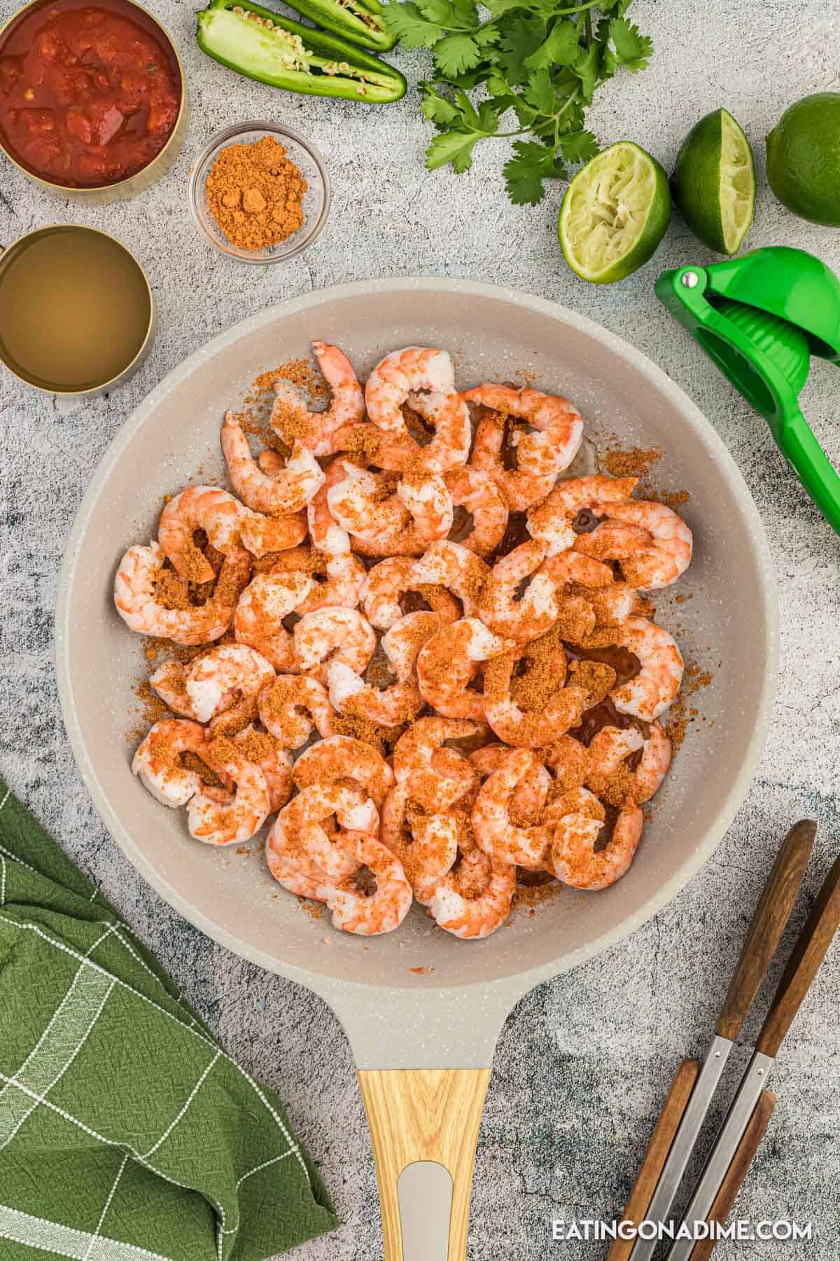 Shrimp in a skillet topped with taco seasoning