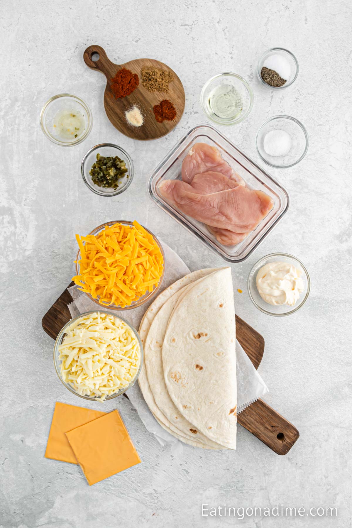 Ingredients needed for Taco Bell Chicken Quesadillas - Mayonnaise, pickled jalapenos, sugar, cumin, paprika, cayenne pepper, garlic powder, chicken, oil, salt and pepper, flour tortillas, cheese, 