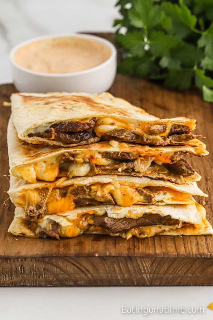 Steak Quesadilla sliced and stacked on a cutting board
