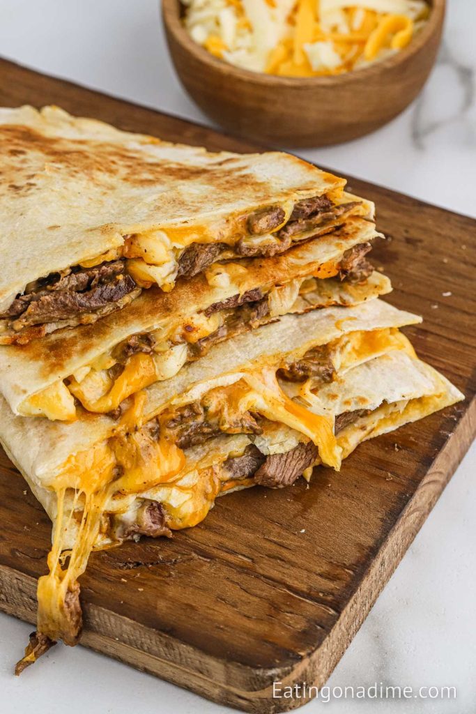 Steak Quesadilla sliced and stacked on a cutting board
