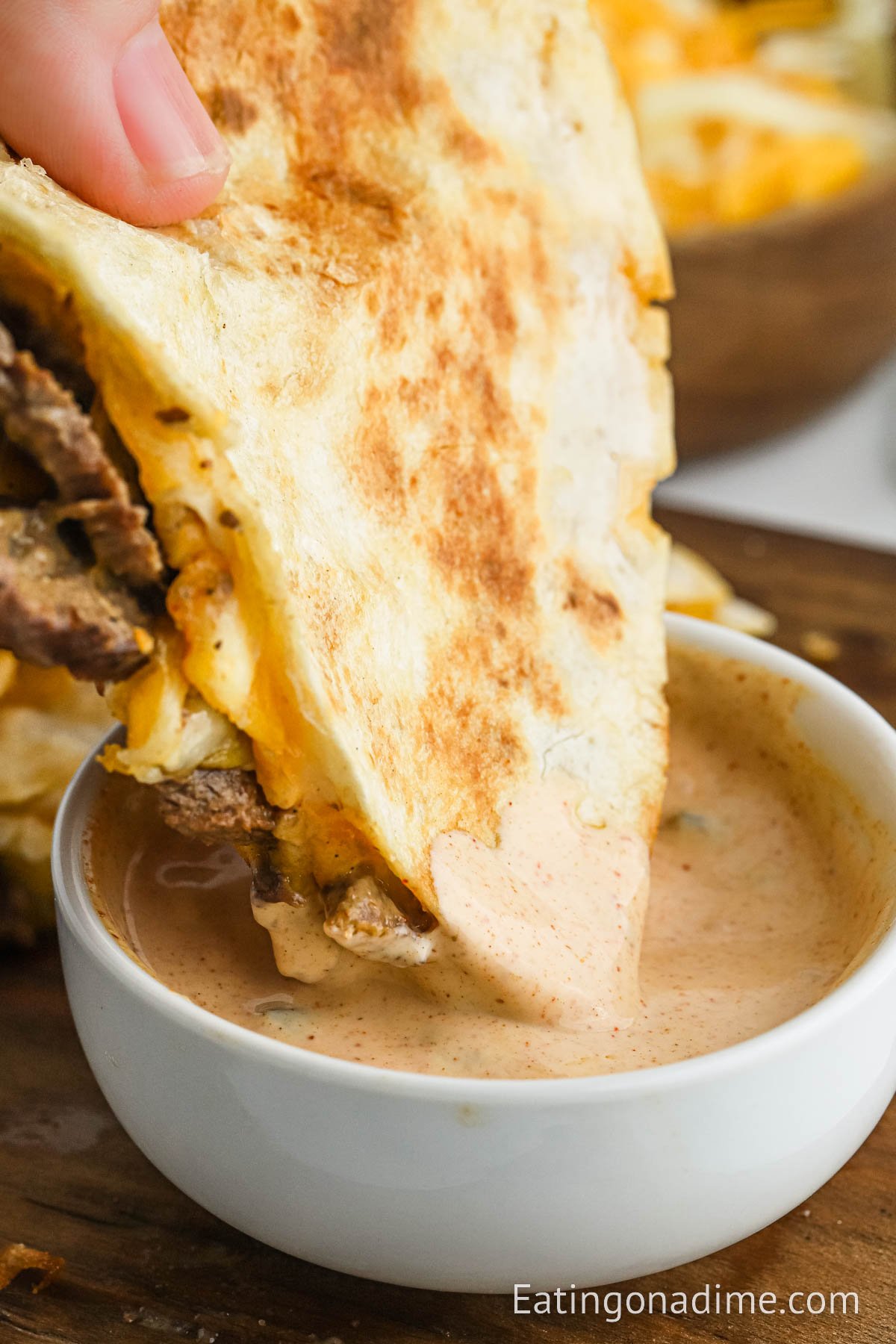 Steak Quesadilla dipping in sauce