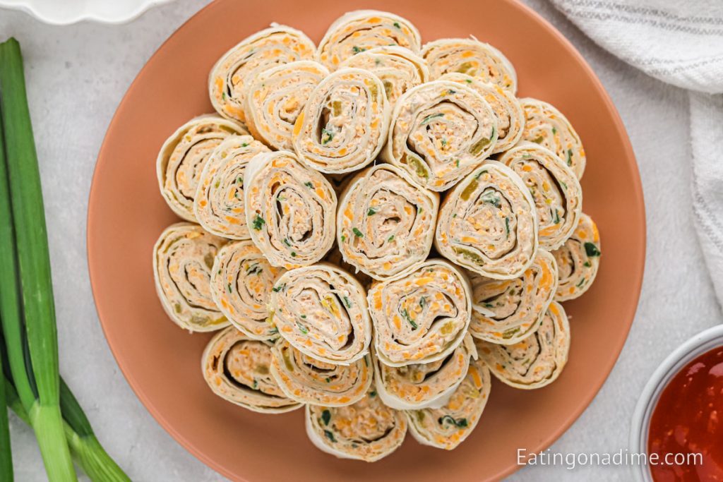 Tortilla rolls ups stacked on a plate