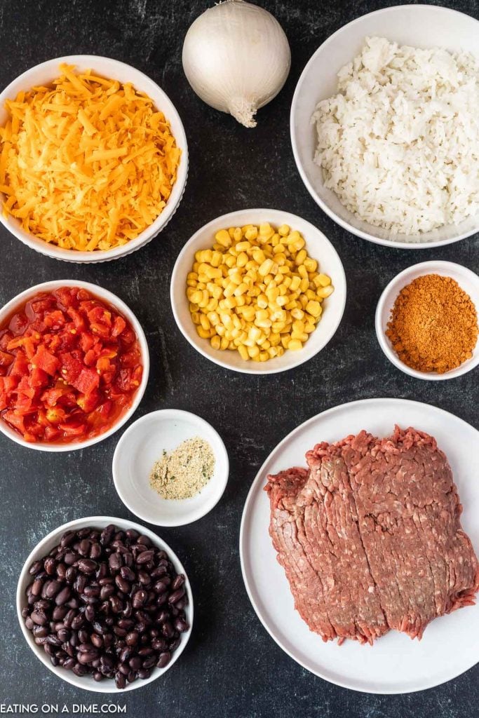 Ingredients needed - ground beef, onion, corn, black beans, diced tomatoes, taco seasoning, garlic salt, cooked rice, cheese