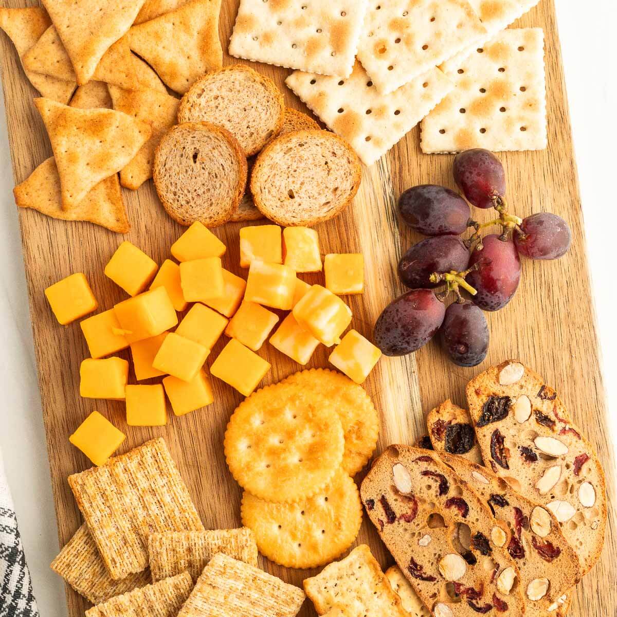 Charcuterie board with cheese, fruit and crackers