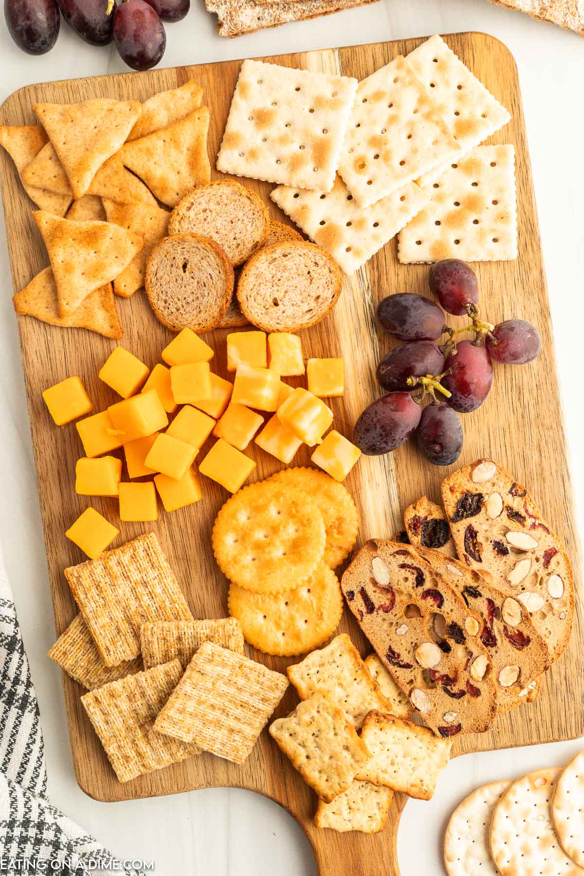 Charcuterie board with cheese, fruit and crackers